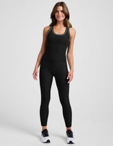 Woman wearing a black athletic outfit on a white background